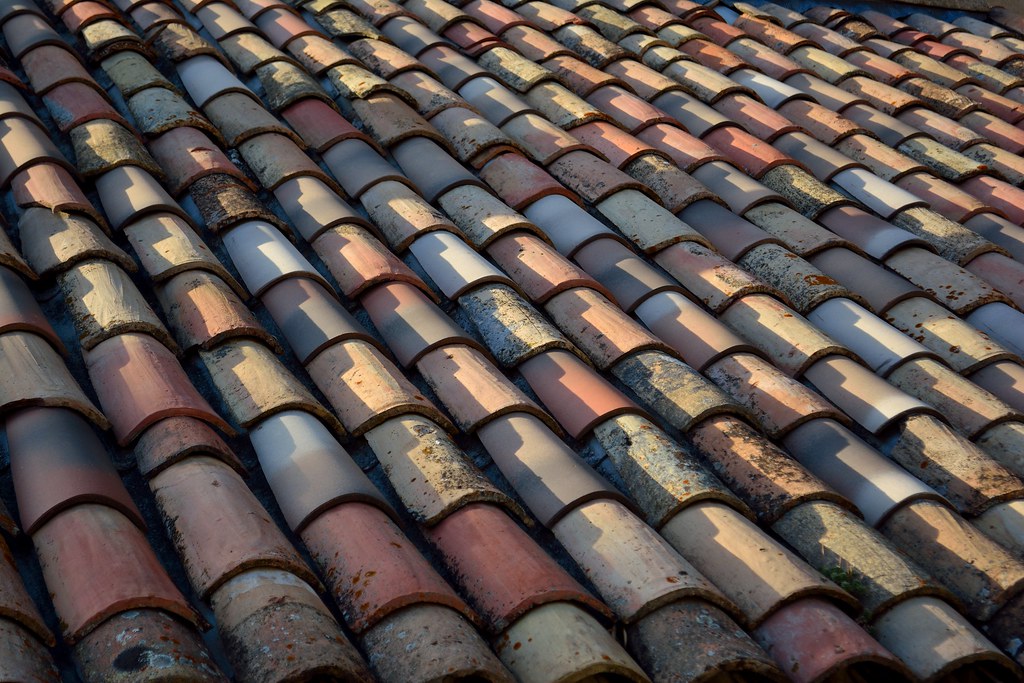 Weathered terracotta roof tiles showing years of sun and wear